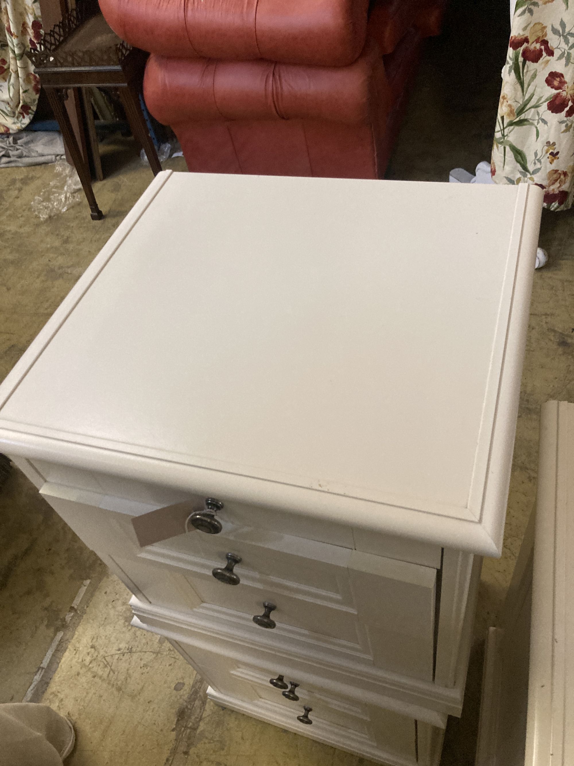 A contemporary white five drawer chest, together with a pair of matching three drawer bedside chests, larger width 105cm depth 50cm hei